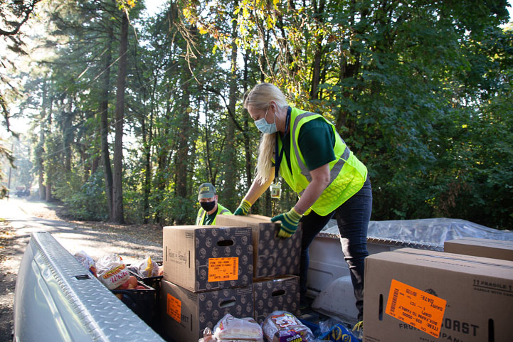 Woman unloads food from truck