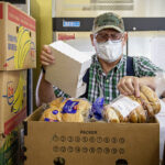Pantry volunteer Jack sorts food at the Mill City/Gates Community Assistance Center. Verbal only release.