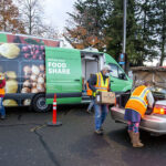 Food Share staff and volunteers load food boxes into a car at Chemeketa Community College on Nov. 10, 2020. 