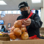 Kiko shops for food during a mobile pantry distribution held with Micronesian Islander Community at Chemeketa Community College.