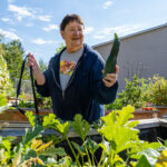 Linda M. harvests produce from her plot at Englewood Garden.