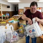 Ray shops for food at Dallas Seventh-day Adventist Church's food pantry, which he relies on for relief as food prices remain high.