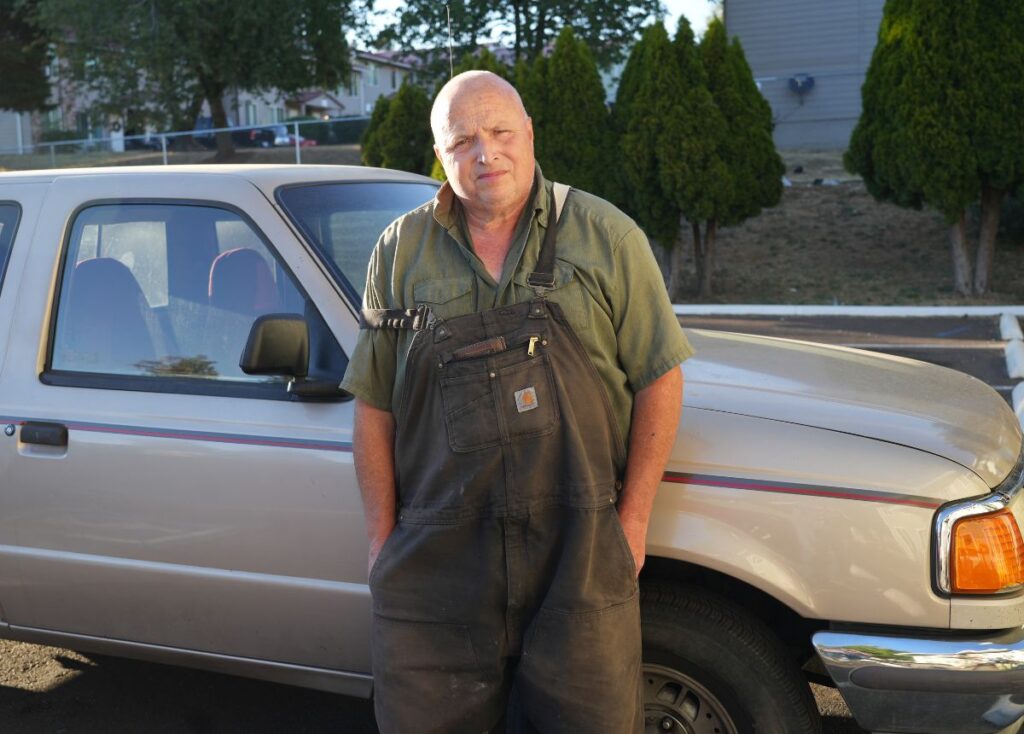 Brant standing in front of his tan Ford Ranger