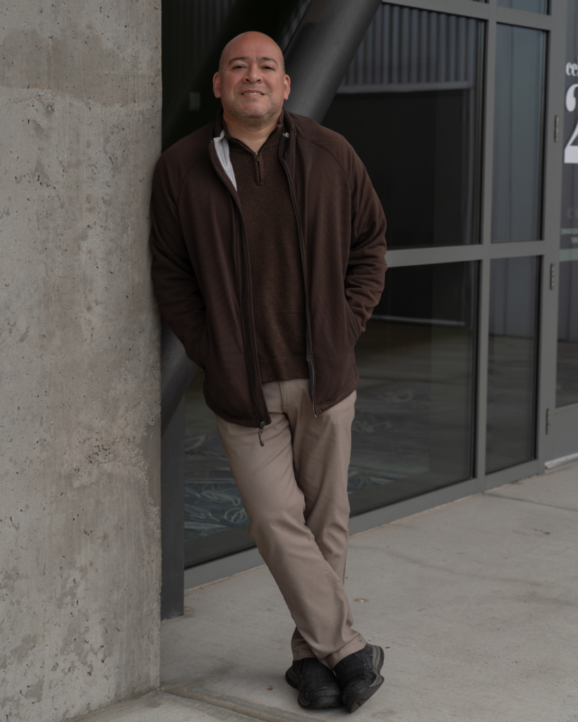 Sam Parra leans against a concrete pillar at the Salem Convention Center