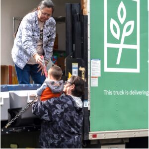 Francene, Grand Ronde Program Manager, hands Guadalupe a snack for Lusio