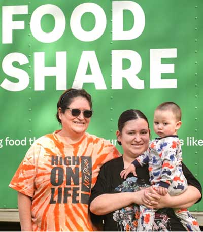 Guadalupe, Maria, and Lusio at a mobile food pantry distribution.